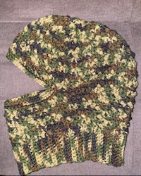 a camouflage knitted hat on a couch