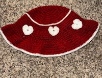 a red and white crocheted hat